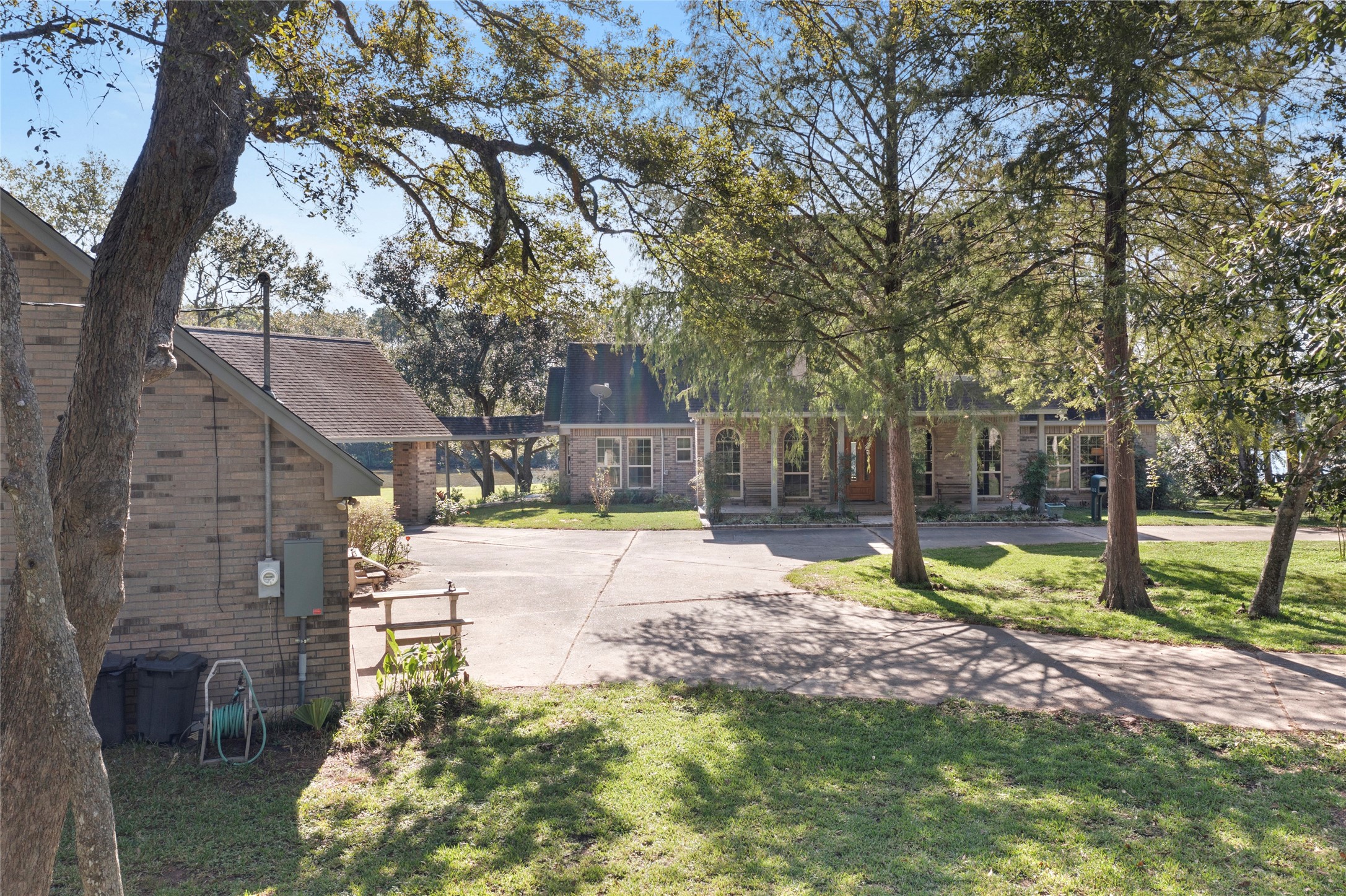 860 FM 517 Road East Dickinson, TX 77539 - Photo 45 of 50 a view of a yard with plants and a large tree