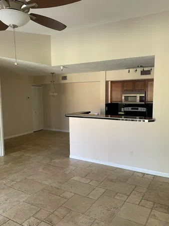 a view of kitchen with stainless steel appliances cabinets and a counter top