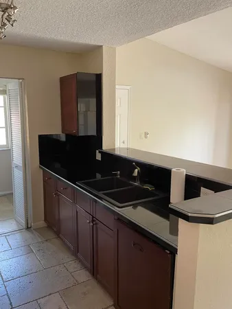 a kitchen with a sink and a stove
