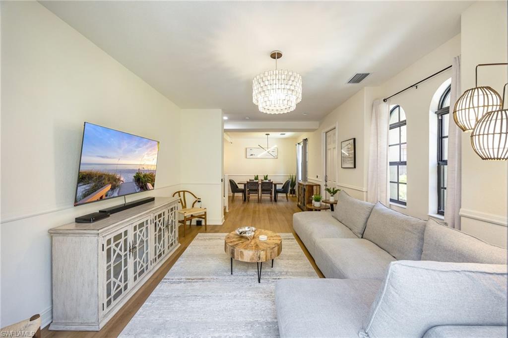 9128 Delano Street, Unit 892 Naples, FL 34113 - Photo 12 of 49 a living room with furniture and a flat screen tv