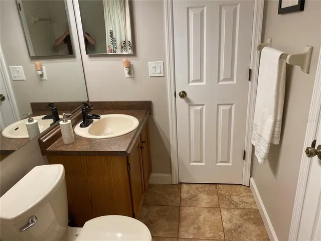 a bathroom with a sink a toilet and a mirror