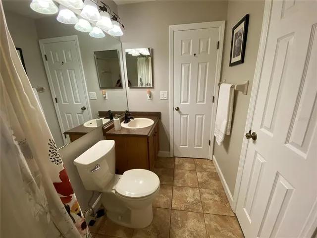 a bathroom with a sink a toilet a mirror and vanity