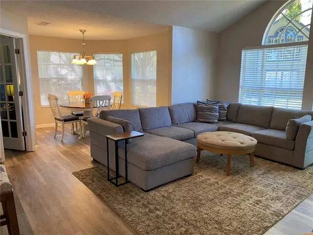 a living room with furniture and a large window