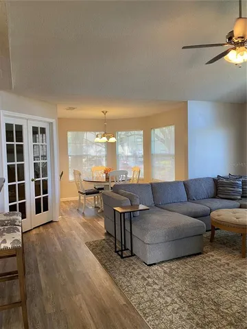 a living room with furniture and large windows