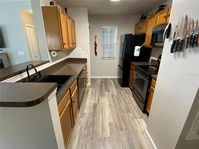a kitchen with a sink and a refrigerator