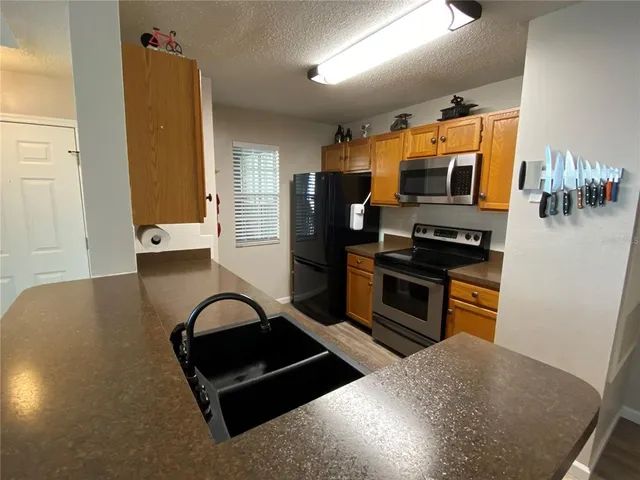 a kitchen with stainless steel appliances granite countertop a stove and a refrigerator