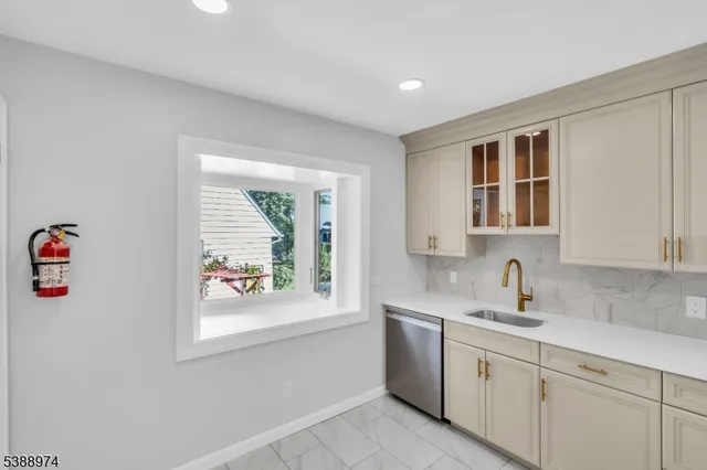 a kitchen with a sink cabinets and window