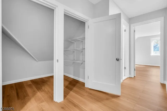 a view of a room with wooden floor