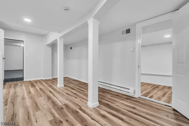 a view of wooden floor and closet in a kitchen