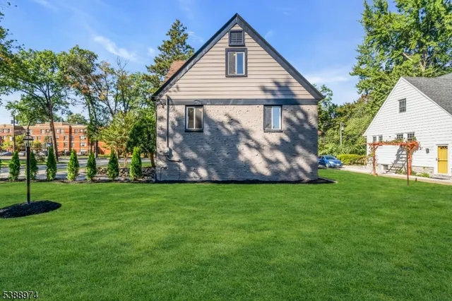 a view of a house with a backyard