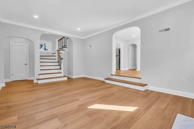a view of a room with wooden floor and stairs