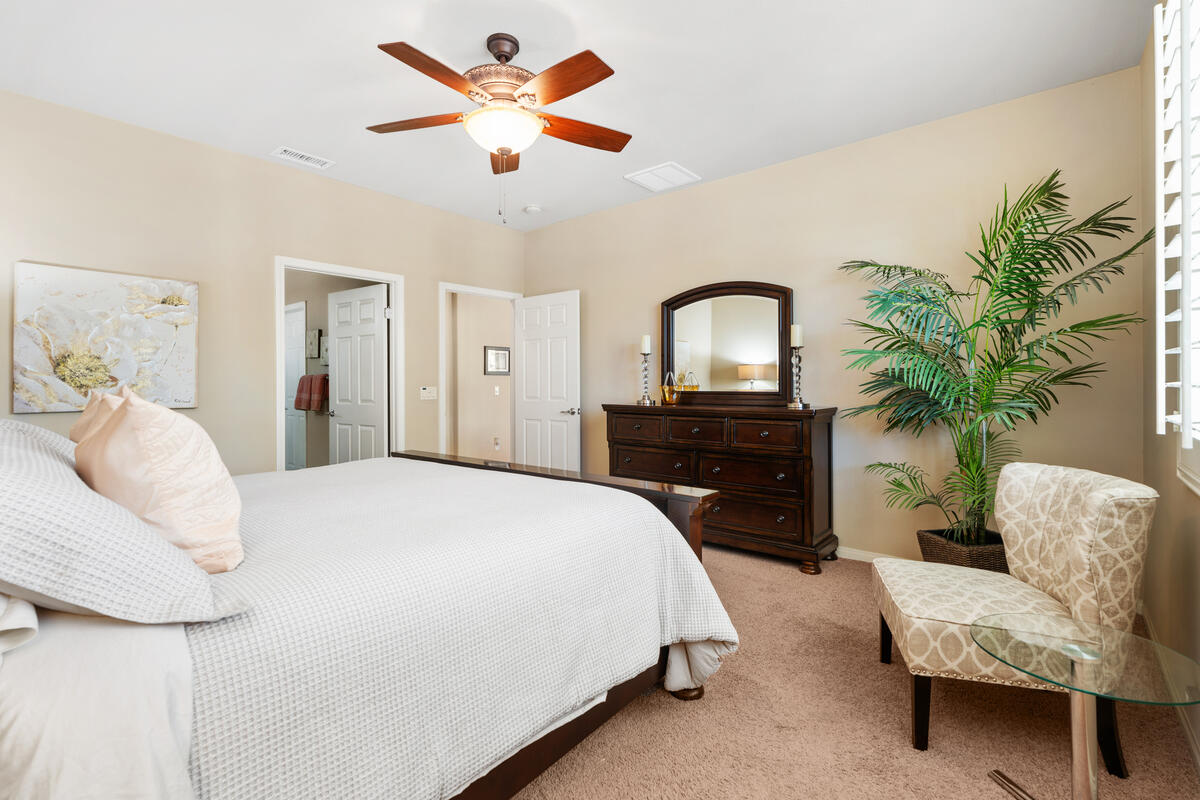 81220 Corte Tolon Indio, CA 92203 - Photo 13 of 42 a spacious bedroom with a bed and a couch