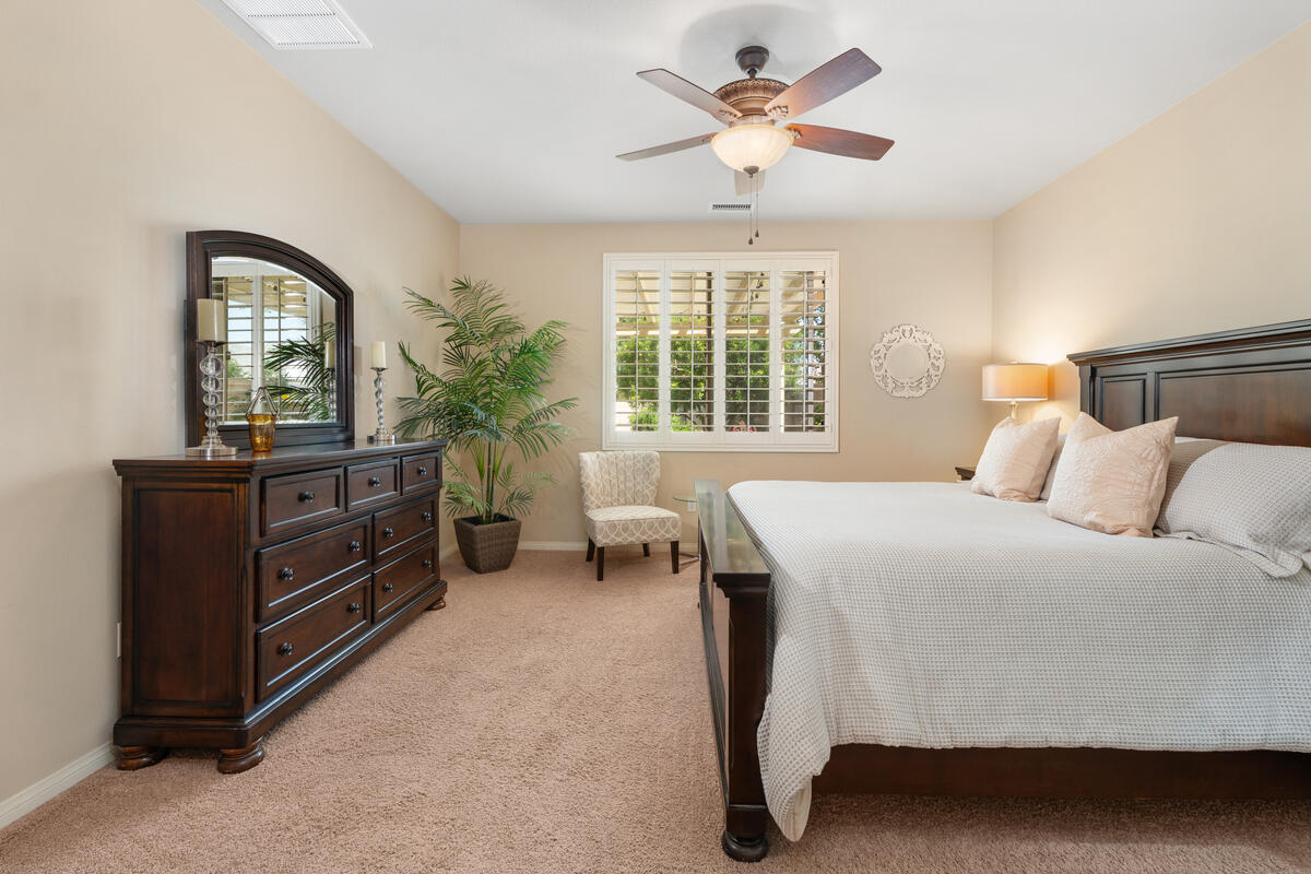 81220 Corte Tolon Indio, CA 92203 - Photo 14 of 42 a bedroom with a bed and a chandelier