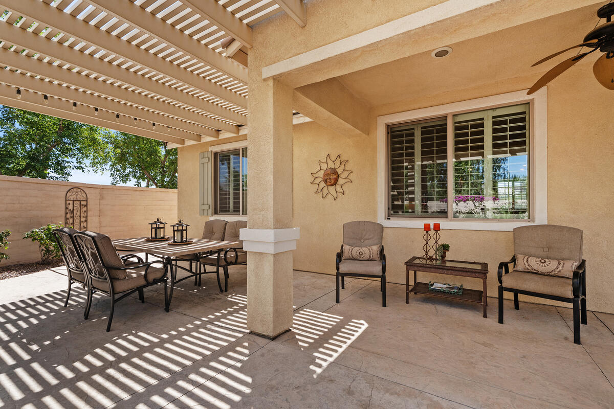 81220 Corte Tolon Indio, CA 92203 - Photo 20 of 42 a view of a patio with table and chairs