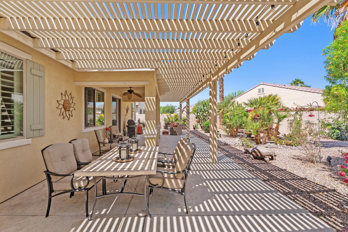 81220 Corte Tolon Indio, CA 92203 - Photo 21 of 42 a view of a patio with couches table and chairs and potted plants
