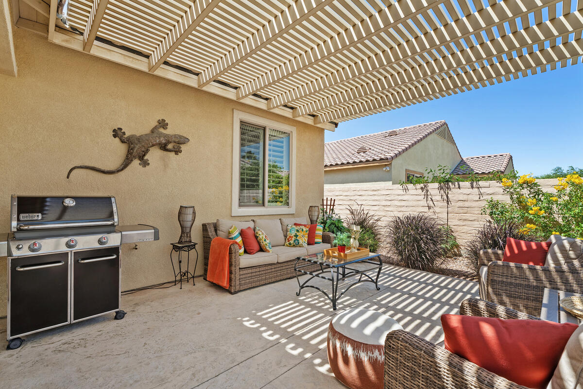 81220 Corte Tolon Indio, CA 92203 - Photo 22 of 42 a living room with furniture a flat screen tv and a kitchen