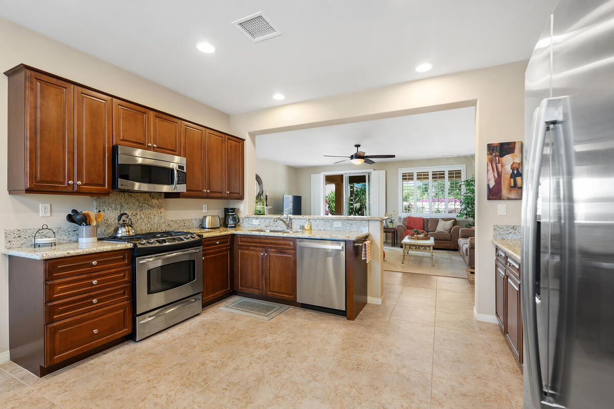 81220 Corte Tolon Indio, CA 92203 - Photo 8 of 42 a kitchen with sink cabinets and stainless steel appliances