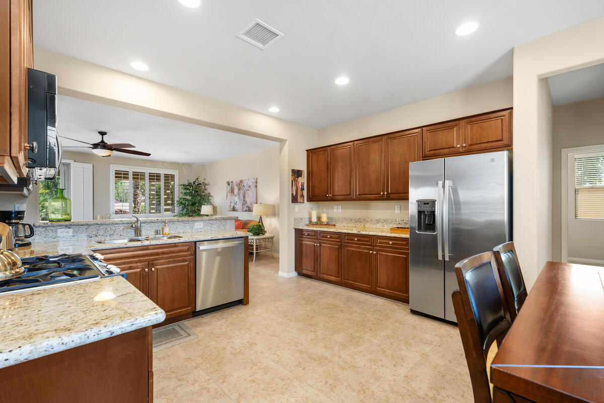 81220 Corte Tolon Indio, CA 92203 - Photo 9 of 42 a kitchen with stainless steel appliances granite countertop a refrigerator a stove top oven a sink and dishwasher