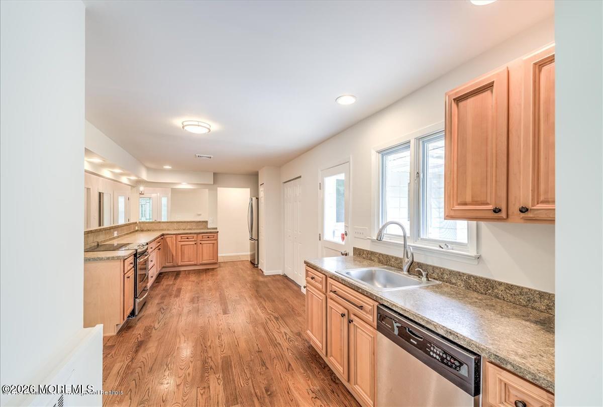 699 Aldrich Road Howell, NJ 07731 - Photo 5 of 23 a large kitchen with granite countertop a large window a sink and stainless steel appliances