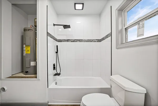 a bathroom with a toilet and a bathtub