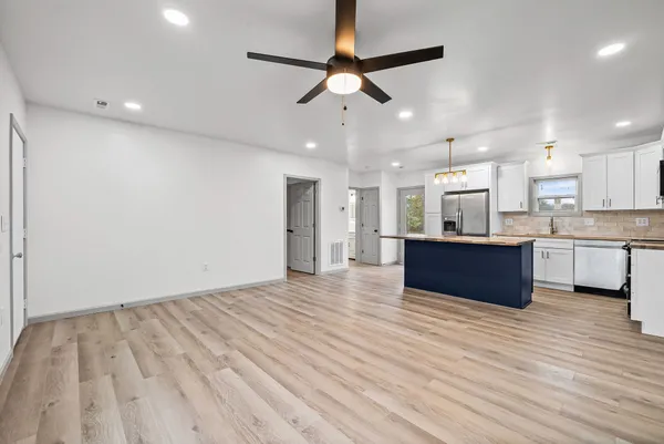 a view of kitchen with wooden floor and electronic appliances
