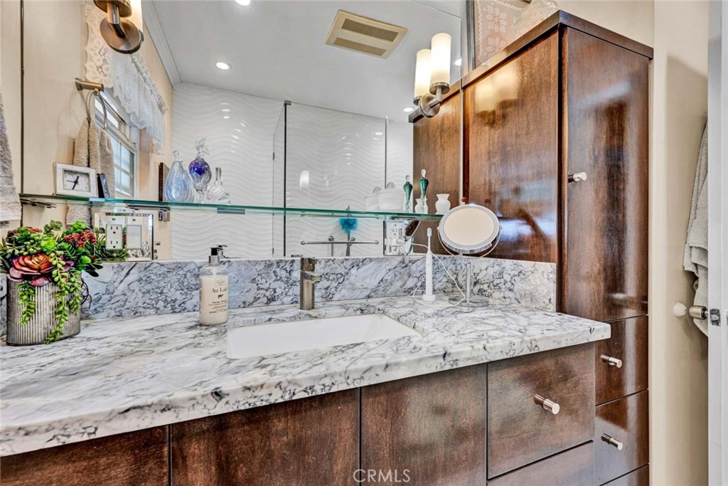 5456 Cadbury Road Whittier, CA 90601 - Photo 18 of 67 a bathroom with a granite countertop sink and a mirror