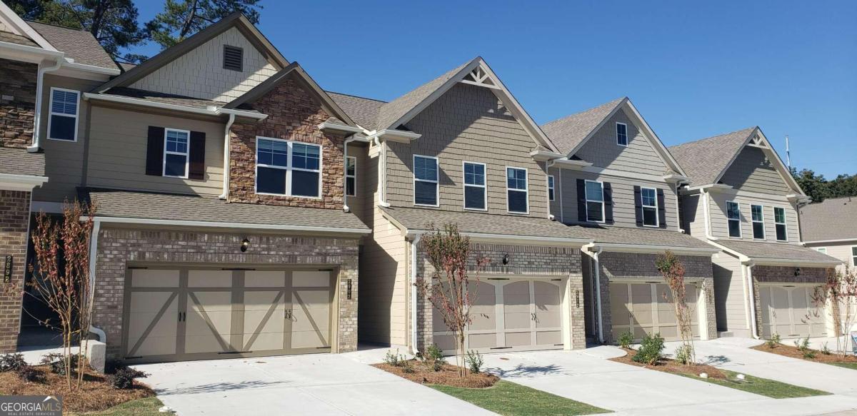 2812 Cadence Walk Road, Unit 48 Peachtree Corners, GA 30360 - Photo 1 of 1 a front view of a house with a yard