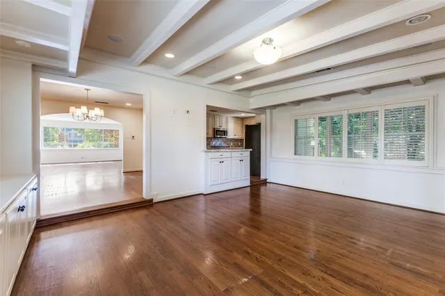 a large kitchen with stainless steel appliances granite countertop a refrigerator and a stove