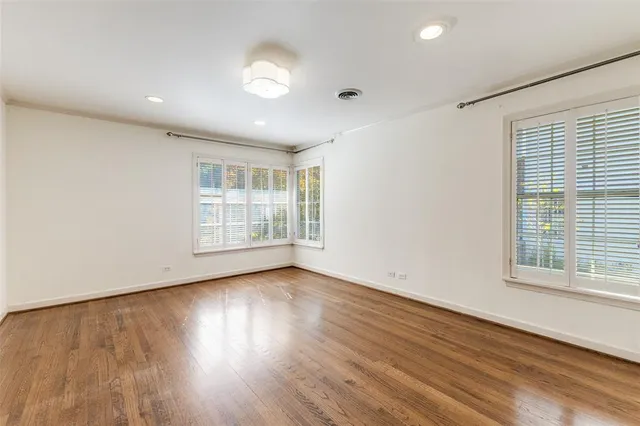a view of a kitchen with wooden floor and electronic appliances