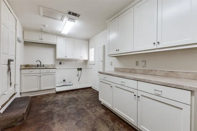 a bathroom with a granite countertop double vanity sink a mirror and shower