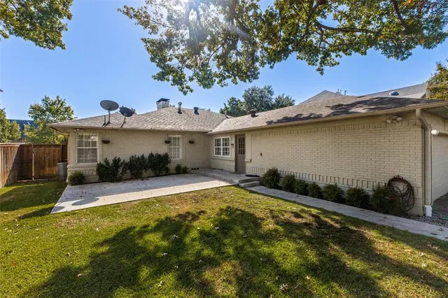 a view of a house with pool and a yard