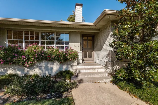 front view of house with potted plants