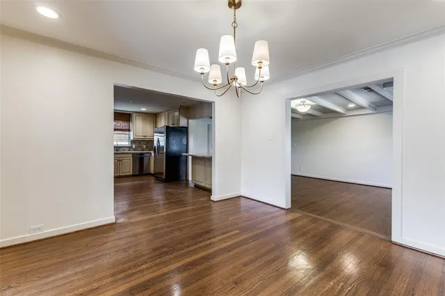 a view of a kitchen with a dishwasher a kitchen wooden floor and a refrigerator
