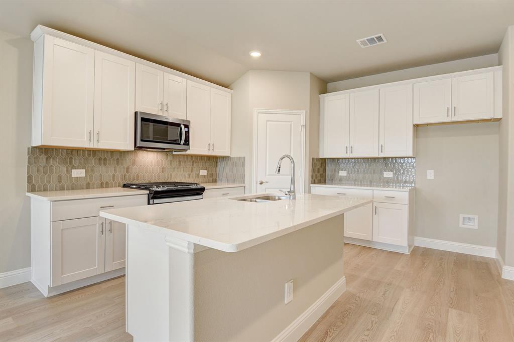1237 Sage Drive Lavon, TX 75166 - Photo 1 of 1 a kitchen with appliances a sink and cabinets