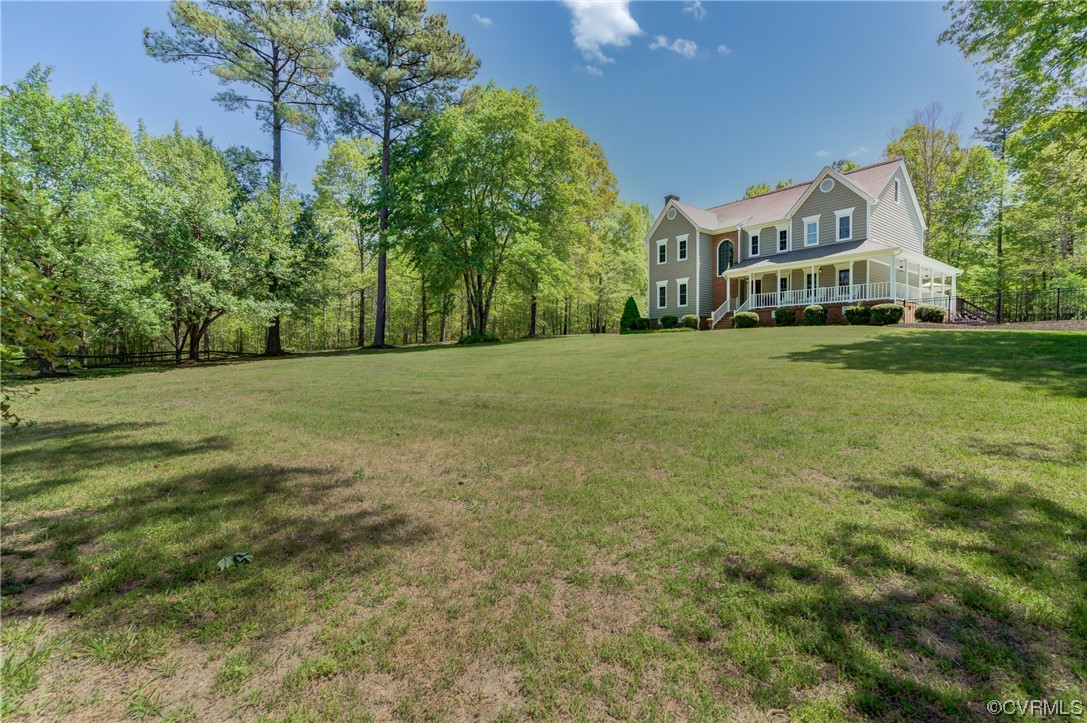 5101 Moseley Road Moseley, VA 23120 - Photo 2 of 46 a view of a big house with a big yard and large trees