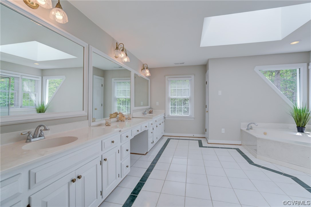 5101 Moseley Road Moseley, VA 23120 - Photo 28 of 46 a spacious bathroom with a granite countertop sink a toilet a mirror and bathtub