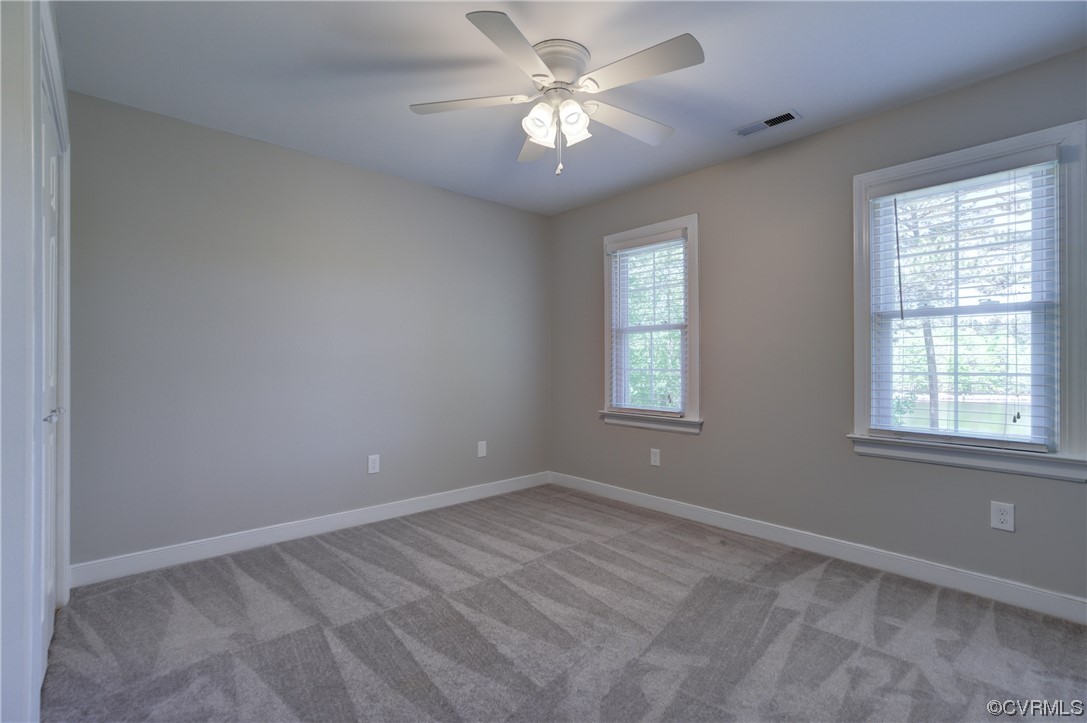 5101 Moseley Road Moseley, VA 23120 - Photo 30 of 46 an empty room with windows and ceiling fan