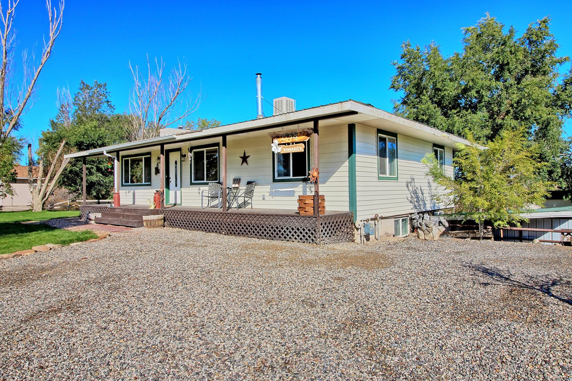 1758 L L 1/2 Road Fruita, CO 81521 - Photo 8 of 42 a front view of a house with yard and a tree