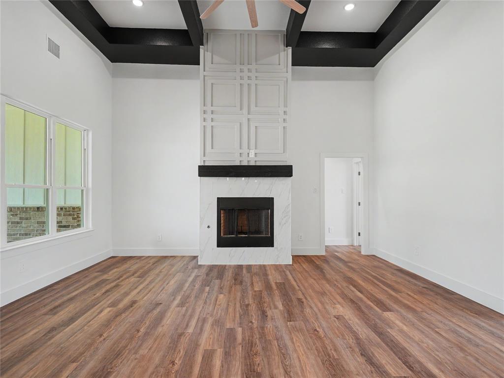 328 Slimp Bluff Azle, TX 76020 - Photo 7 of 30 Spacious interior featuring high ceilings with dark contrasting beams and recessed lighting