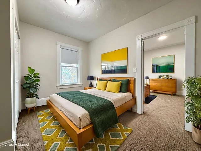 a bedroom with a bed and a couch