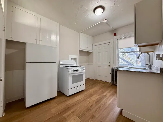 a kitchen with stainless steel appliances a refrigerator and a stove top oven
