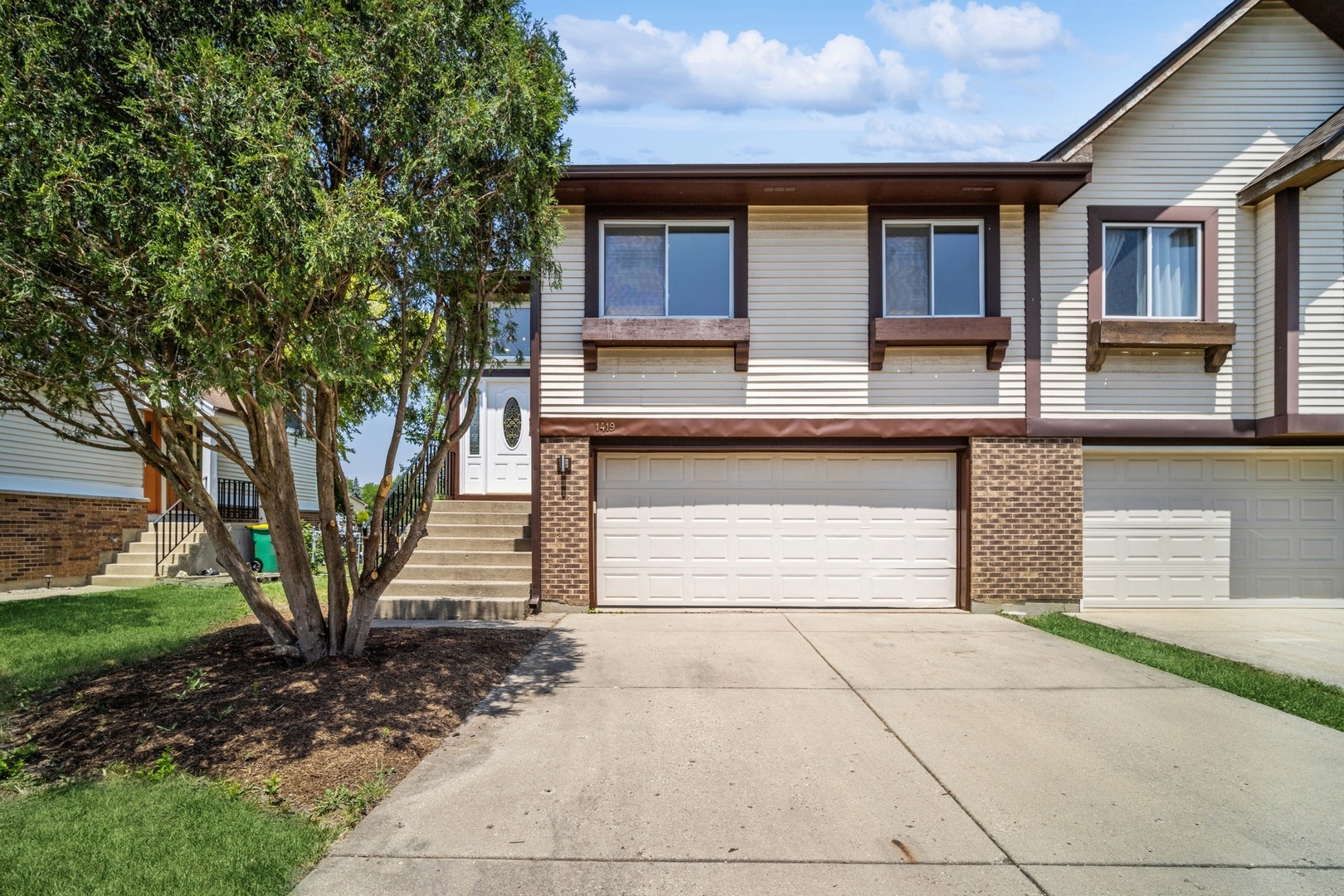 a front view of a house with garden