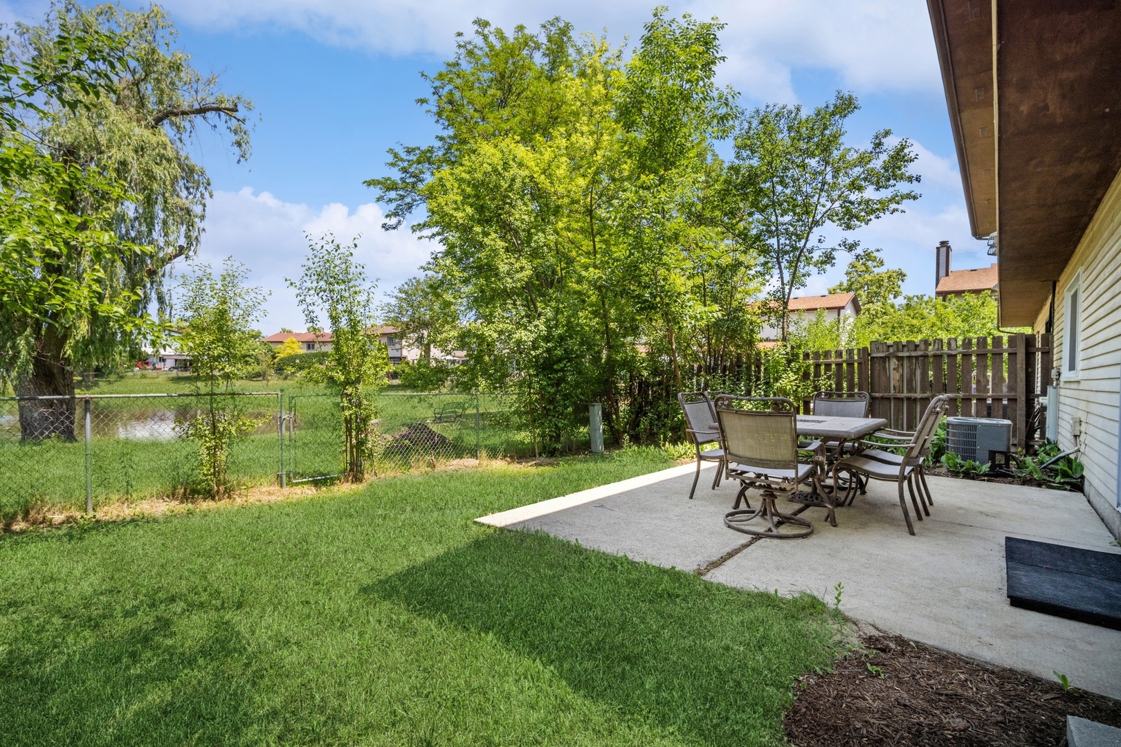 1419 Chippewa Trail Wheeling, IL 60090 - Photo 12 of 13 a view of a patio with table and chairs potted plants and large tree