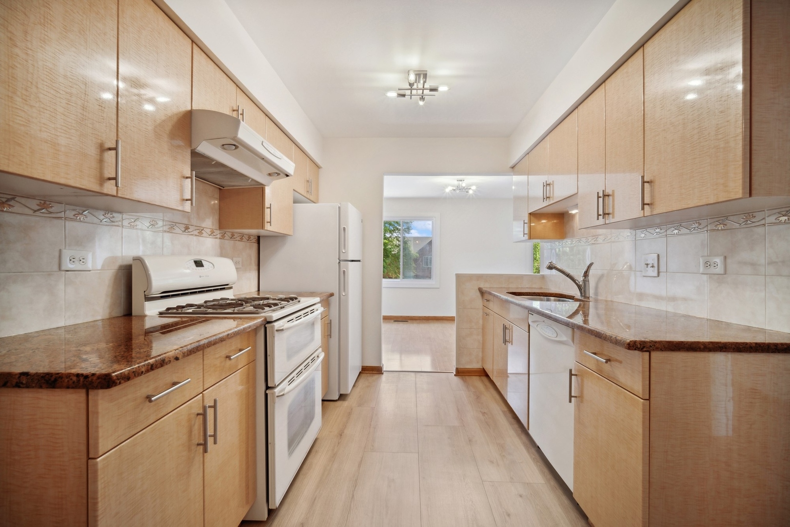 1419 Chippewa Trail Wheeling, IL 60090 - Photo 4 of 13 a kitchen with granite countertop a sink a stove refrigerator and cabinets