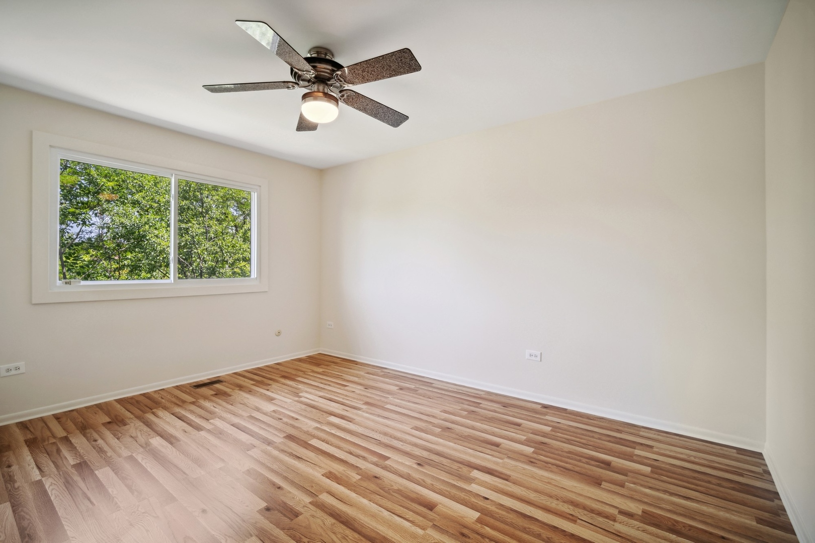 1419 Chippewa Trail Wheeling, IL 60090 - Photo 6 of 13 wooden floor in an empty room with a window