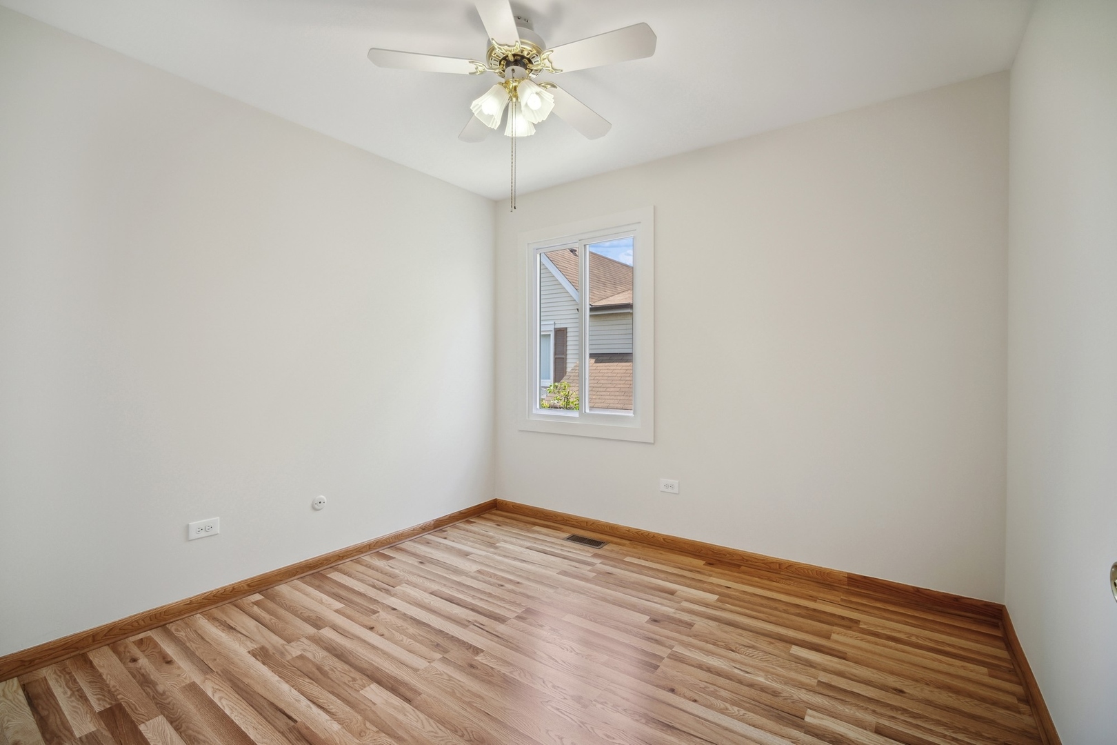 1419 Chippewa Trail Wheeling, IL 60090 - Photo 8 of 13 wooden floor in an empty room with a window