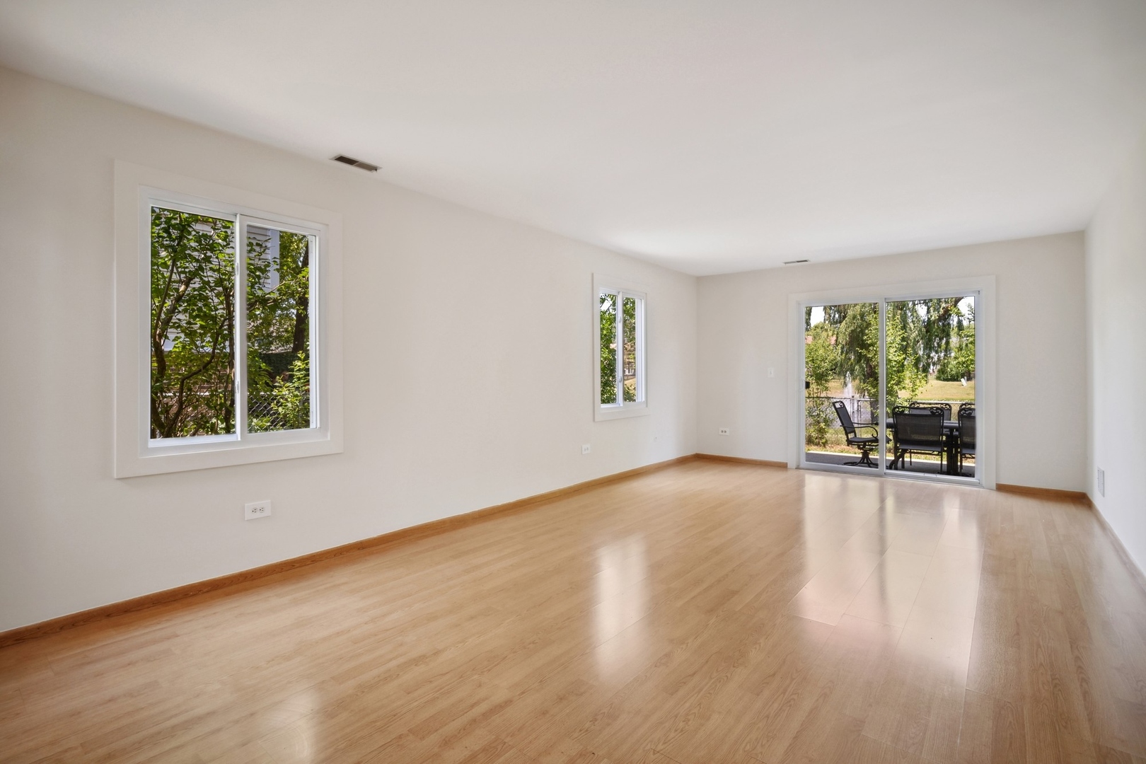 1419 Chippewa Trail Wheeling, IL 60090 - Photo 9 of 13 a view of an empty room with wooden floor and a window