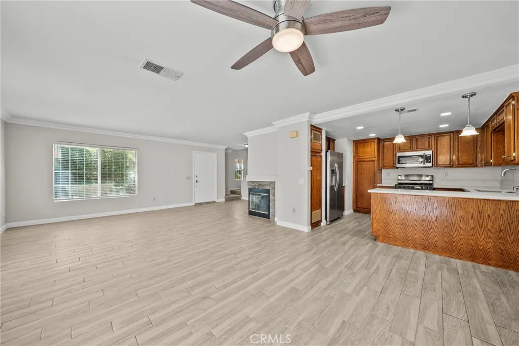 25118 Steinbeck Avenue Stevenson Ranch, CA 91381 - Photo 11 of 34 a view of a kitchen with a sink and a refrigerator