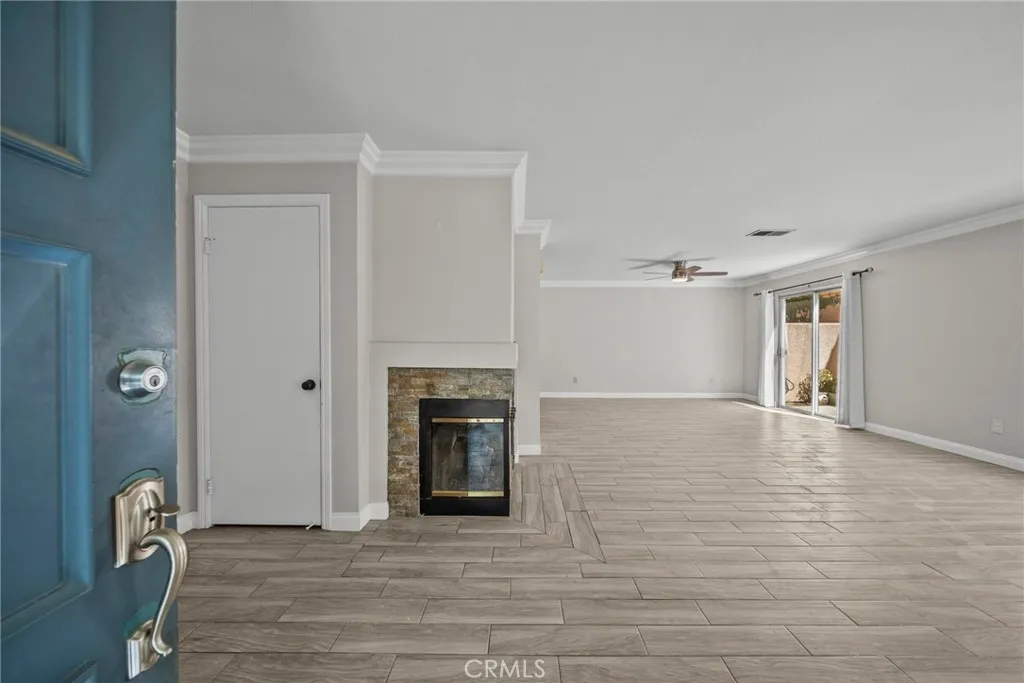 25118 Steinbeck Avenue Stevenson Ranch, CA 91381 - Photo 2 of 34 a view of empty room with wooden floor and fireplace