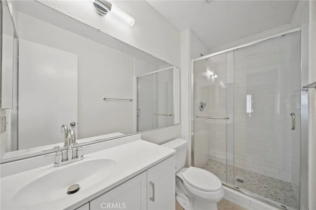 25118 Steinbeck Avenue Stevenson Ranch, CA 91381 - Photo 21 of 34 a bathroom with a sink a toilet and shower